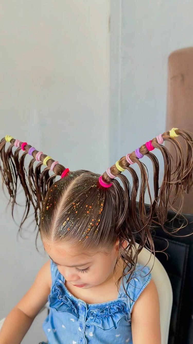 10 Little Rubber Bands for Hairstyles Kids Love 5 Young girl with brown hair in bubble pigtails secured by colorful rubber bands.