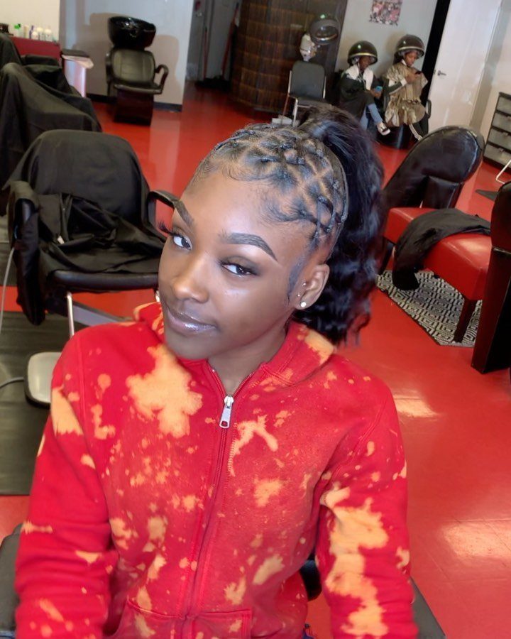 10 Little Rubber Bands for Hairstyles Kids Love 1 Woman with a criss-cross rubber band ponytail wearing a red tie-dye hoodie.