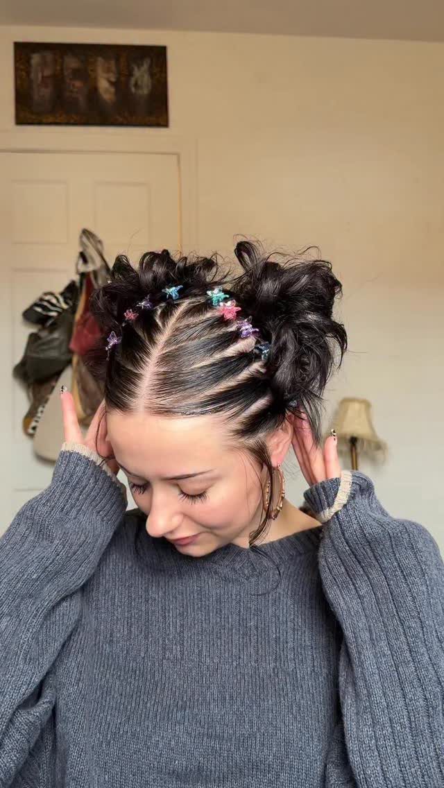 10 Little Rubber Bands for Hairstyles Kids Love 4 Woman with dark hair styled in space buns with colorful star rubber bands.