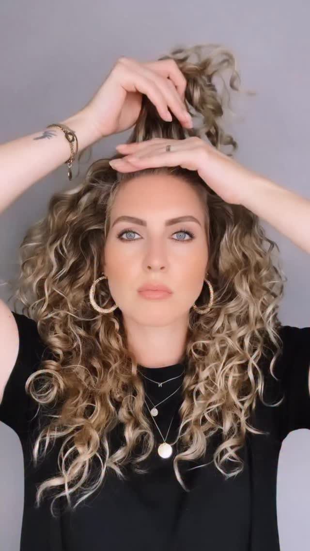 Long 3c Curly Hair Looks, Color and Updos: 15 Picks 14 Woman with long blonde 3c curly hair posing against a grey background.