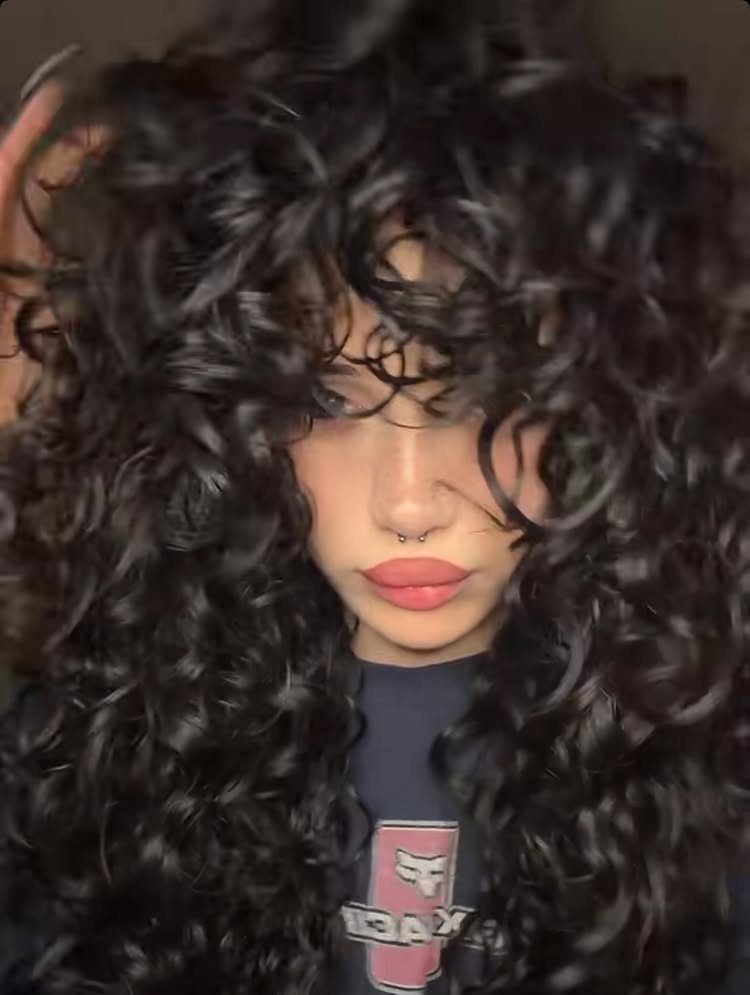 Long 3c Curly Hair Looks, Color and Updos: 15 Picks 9 Person with voluminous long black 3c curly hair and pink lipstick.