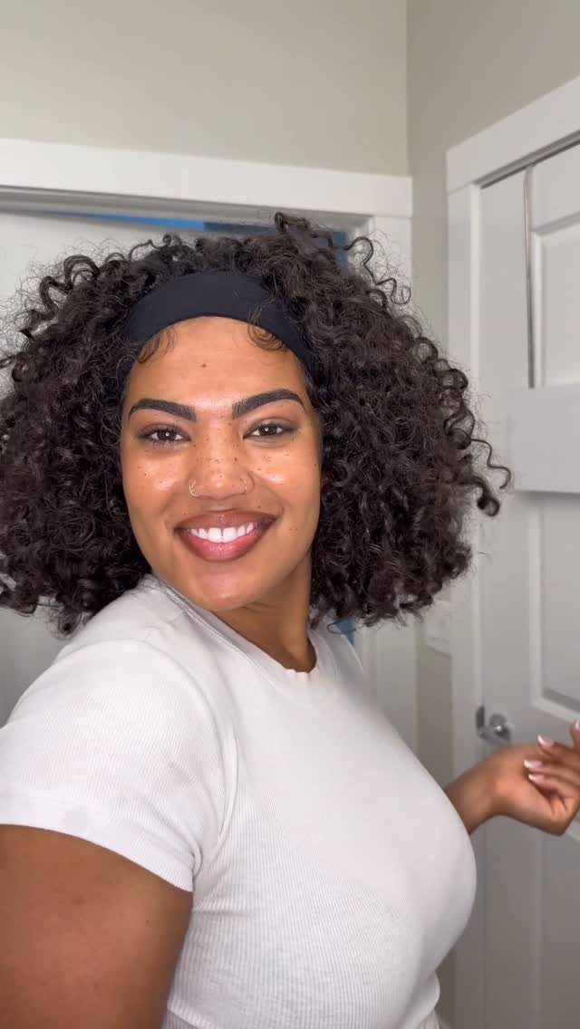 Long 3c Curly Hair Looks, Color and Updos: 15 Picks 8 Woman with voluminous curly hair wearing a black headband and white t-shirt.