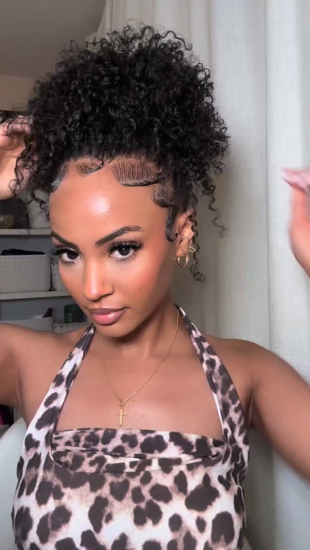 Long 3c Curly Hair Looks, Color and Updos: 15 Picks 5 Woman with voluminous curly hair styled in a high ponytail and laid edges.
