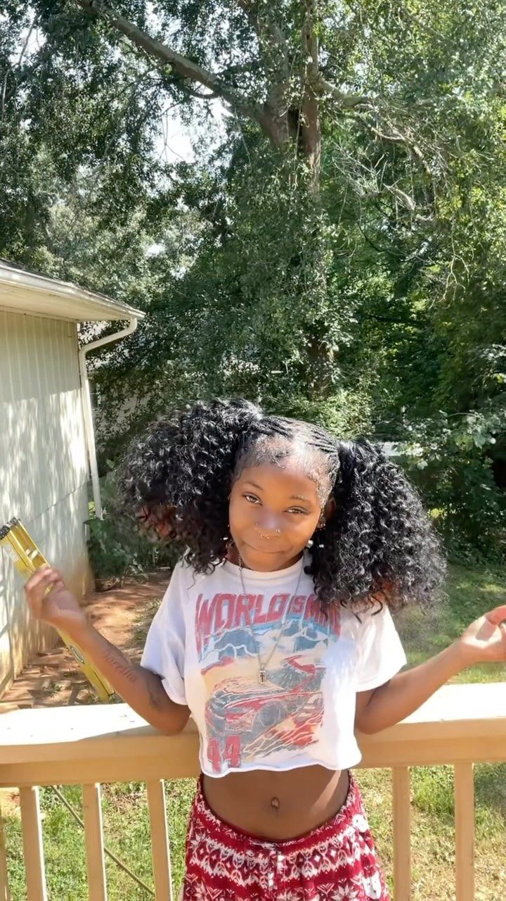 Long 3c Curly Hair Looks, Color and Updos: 15 Picks 13 Young woman with long 3c curly black hair styled in two high pigtails.