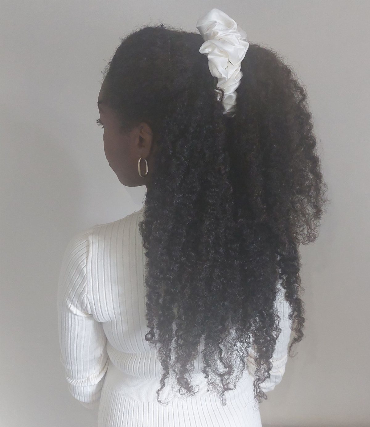 Long 3c Curly Hair Looks, Color and Updos: 15 Picks 10 Woman with long dark curly hair tied with a white satin scrunchie