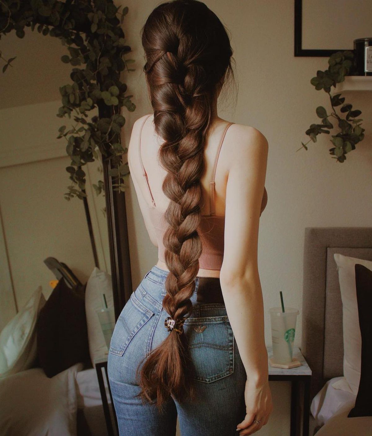 16 Long Hair Hairstyles for Party Looks You Can Copy 8 Woman with long brown hair in a thick, voluminous braid down her back