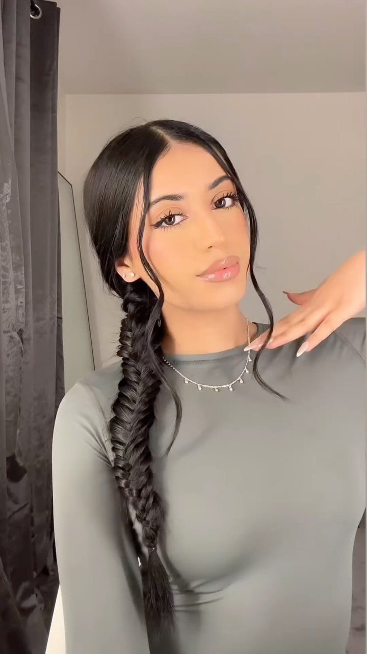 16 Long Hair Hairstyles for Party Looks You Can Copy 2 Woman with long black hair styled in a thick fishtail braid over her shoulder.