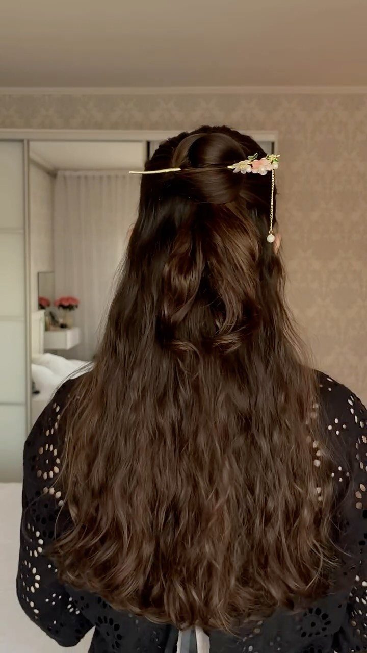 16 Long Hair Hairstyles for Party Looks You Can Copy 11 Long wavy brown hair in a half-up style with a floral gold pin