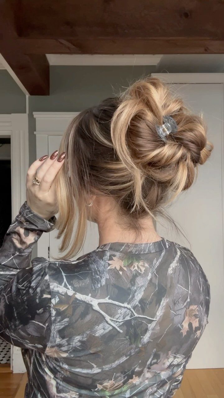 20 Long Hair Hairstyles for Work, From Buns to Braids 12 Blonde hair styled in a messy bun secured with a claw clip.