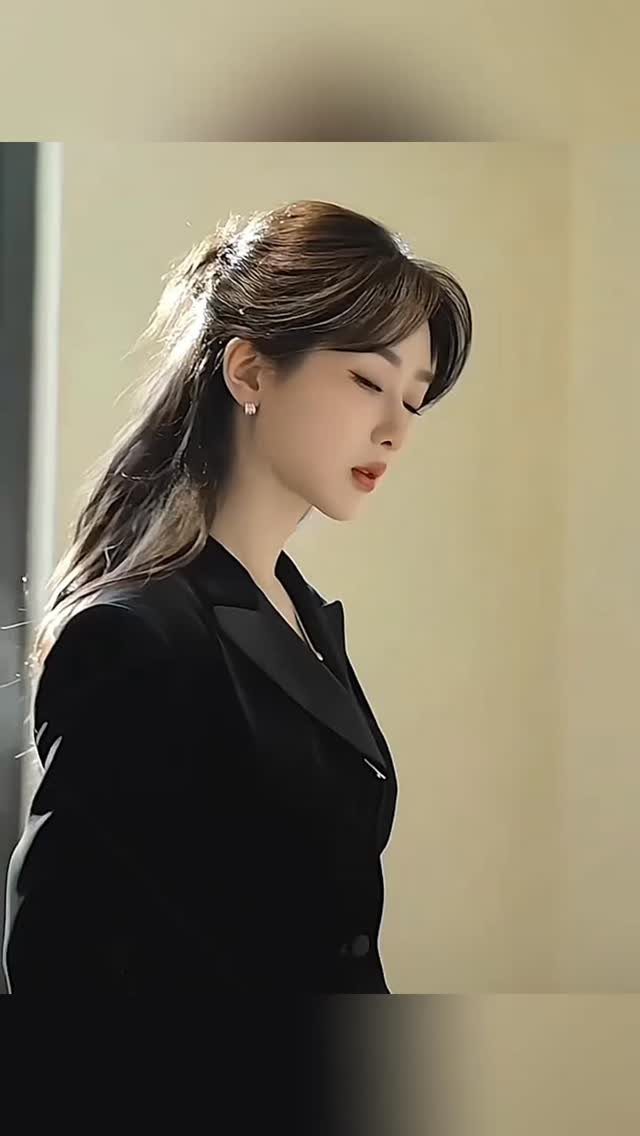 20 Long Hair Hairstyles for Work, From Buns to Braids 17 Woman with long brown hair in a half-up hairstyle wearing a black blazer