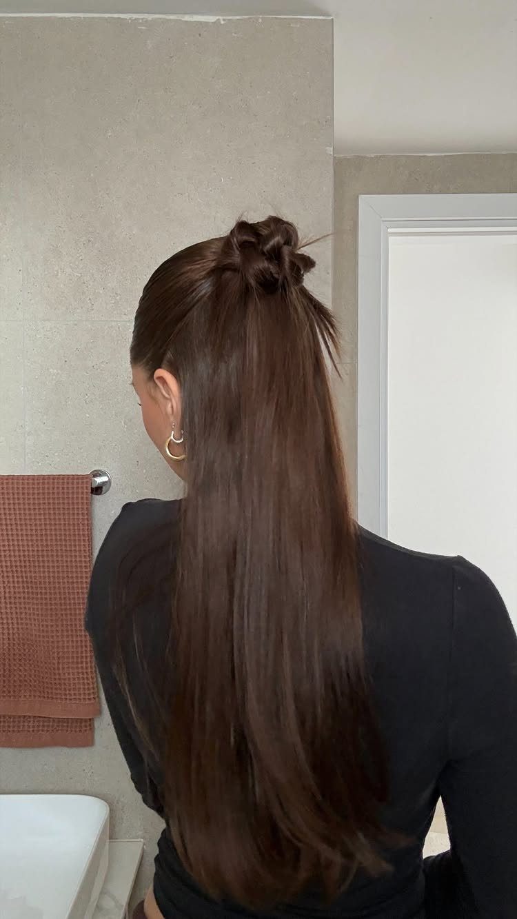 20 Long Hair Hairstyles for Work, From Buns to Braids 19 Woman with long brown hair in a half-up twisted ponytail wearing black shirt