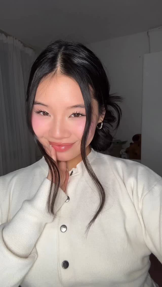 20 Long Hair Hairstyles for Work, From Buns to Braids 15 Woman with long black hair in a professional low bun and white cardigan.