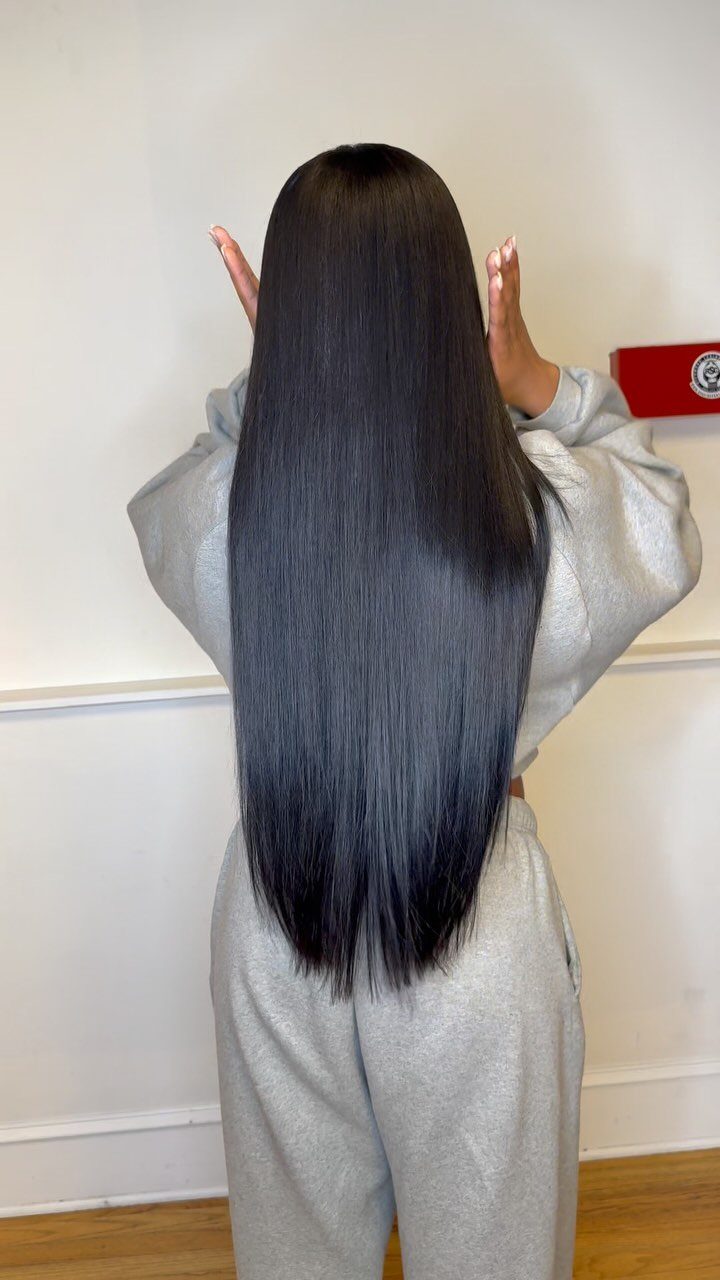 20 Long Hair Hairstyles for Work, From Buns to Braids 9 Long straight sleek black hair falling down the back of a person.