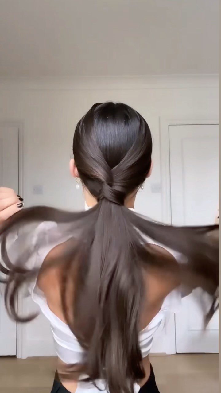20 Long Hair Hairstyles for Work, From Buns to Braids 18 Long brown hair styled in a polished low ponytail with a twisted detail.