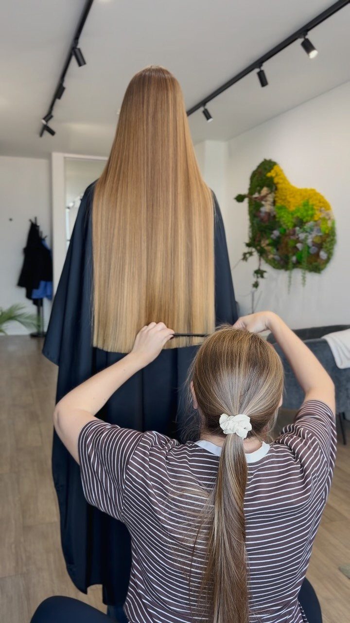 Long Hair Without Layers: 9 One-Length Styles to Try 7 Long straight blonde hair without layers being styled by a professional hairstylist.