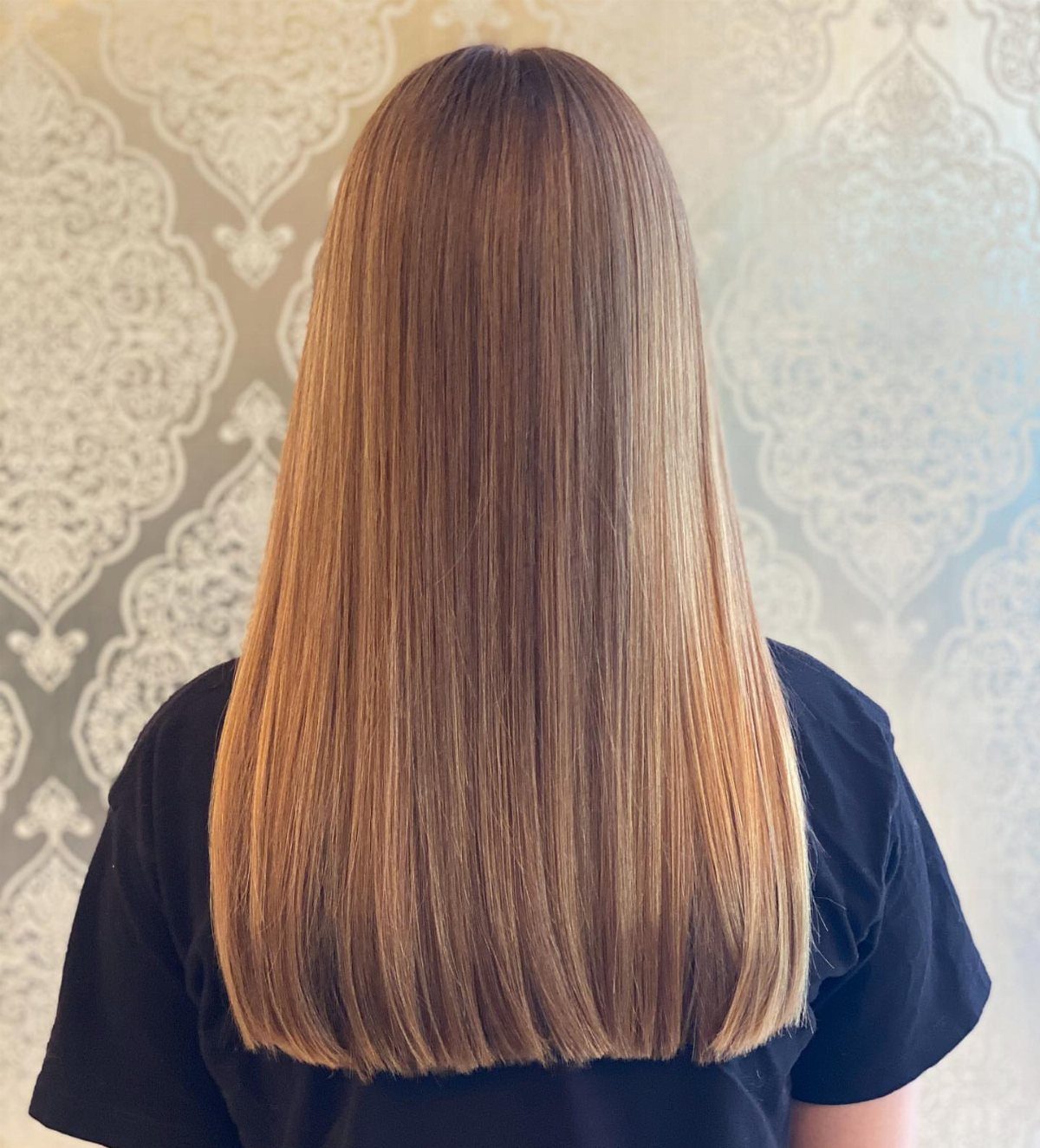 Long Hair Without Layers: 9 One-Length Styles to Try 2 Long straight light brown hair with a blunt cut seen from behind