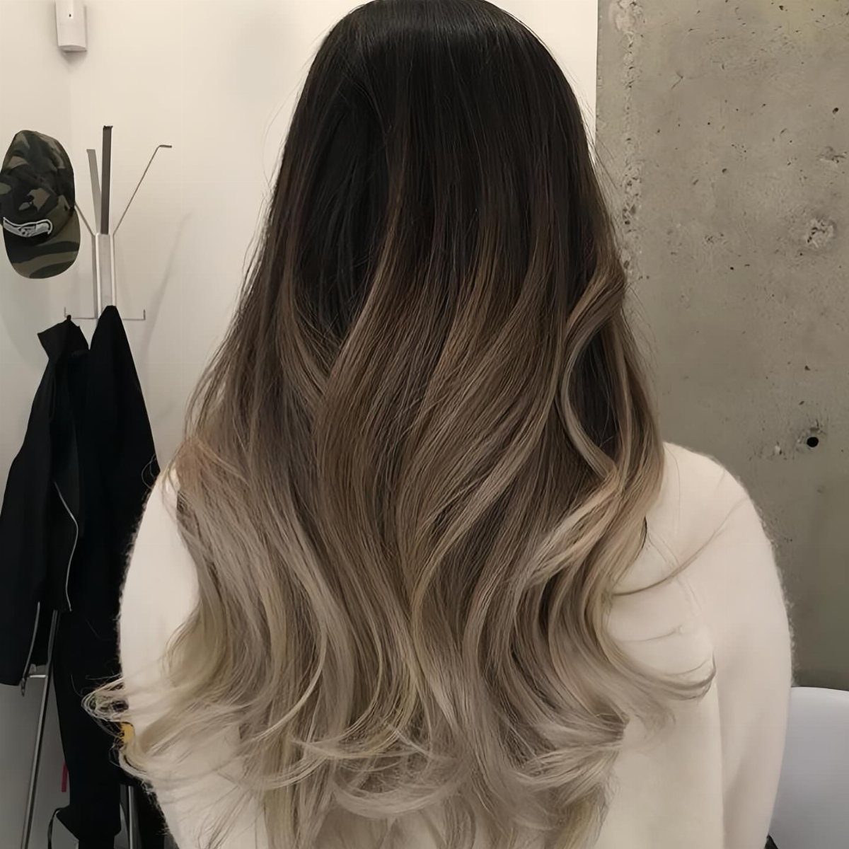 Long Hair Without Layers: 9 One-Length Styles to Try 6 Long wavy hair with dark brown roots fading into light blonde ombre ends.