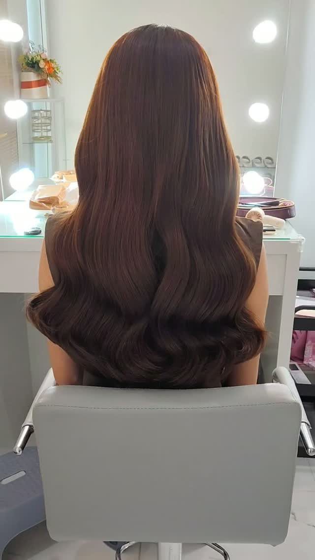 11 Long Loose Hair Ideas for Every Style and Texture 8 Long brown hair styled in polished romantic waves seen from the back in salon