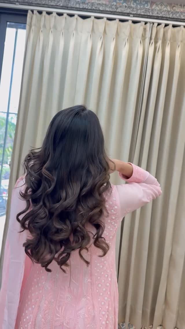 11 Long Loose Hair Ideas for Every Style and Texture 1 Long dark brown hair styled in voluminous curls from a rear view