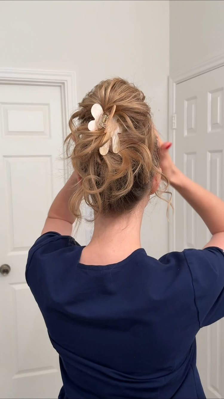 8 Loose Curl Hair Ideas for Blonde, Auburn and Long Looks 1 Blonde hair styled in a messy updo secured with a white claw clip.