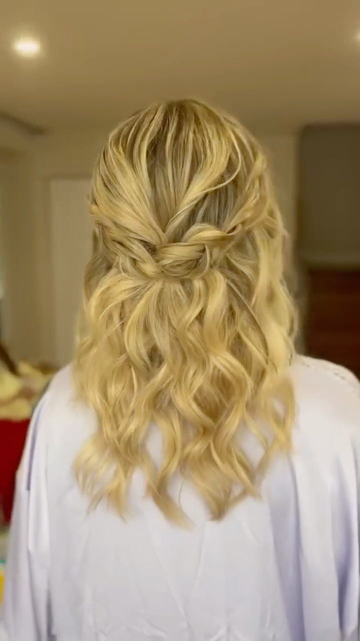 11 Medium Length Curly Hair Hairstyles for Every Look 10 Blonde medium-length curly hair styled in a half-updo with a twisted center knot.