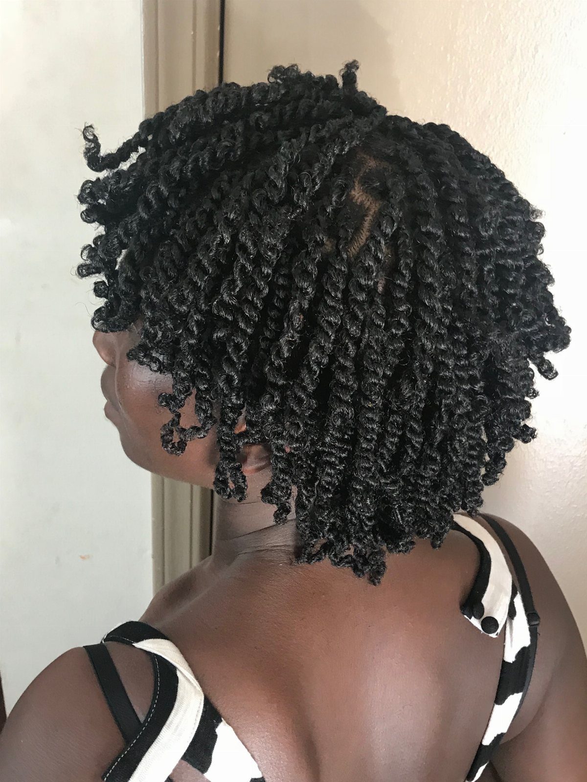 Short black mini twists on a person seen from the side and back.