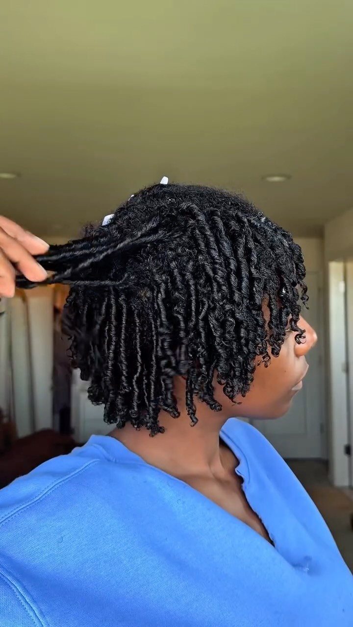 17 Natural Curly Hairstyles for Short Hair You Can Wear 5 Person with short black hair showing defined spiral finger coils in a room