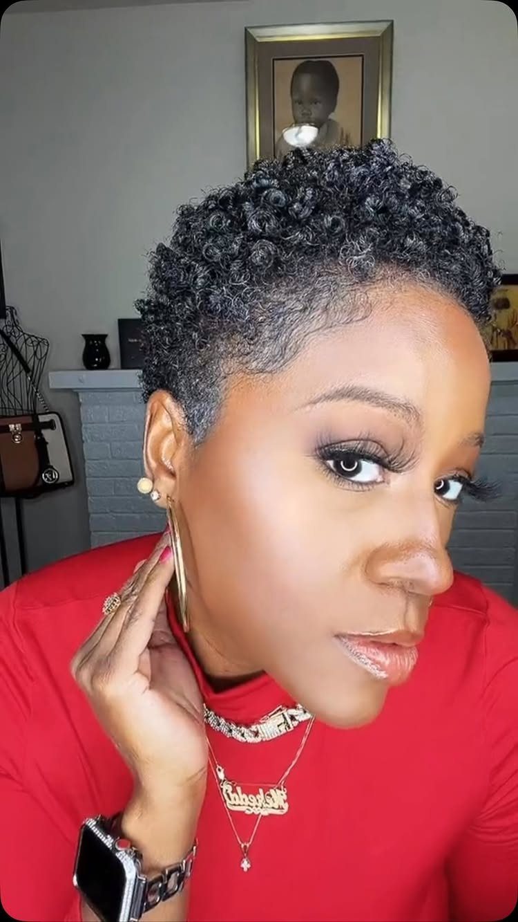17 Natural Curly Hairstyles for Short Hair You Can Wear 8 Woman with a natural tapered cut featuring tight black curls and short sides.