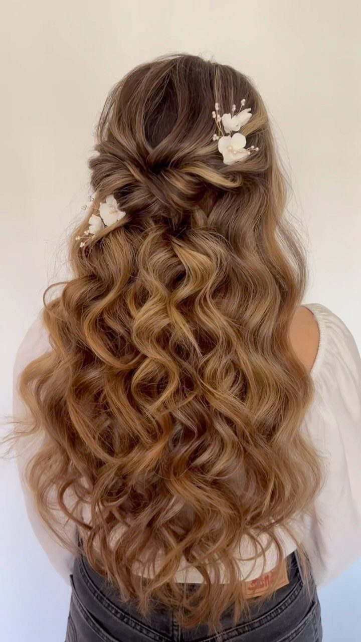 Naturally Curly Prom Hairstyles: 4 Ideas to Try 3 Long honey-blonde curly hair in a half-up style with white floral accessories.