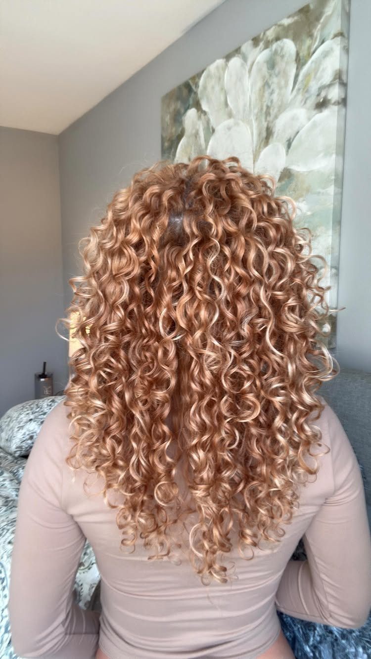 Naturally Curly Prom Hairstyles: 4 Ideas to Try 4 Long golden-blonde naturally curly hair cascading down a person's back.