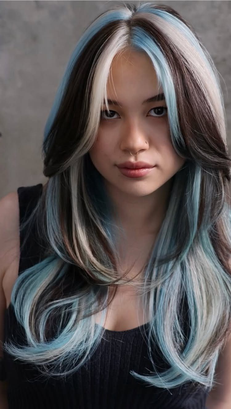 Neapolitan Hair Blue: 5 Ideas for Streaks and Peekaboos 3 Woman with long layered hair featuring white and light blue highlights
