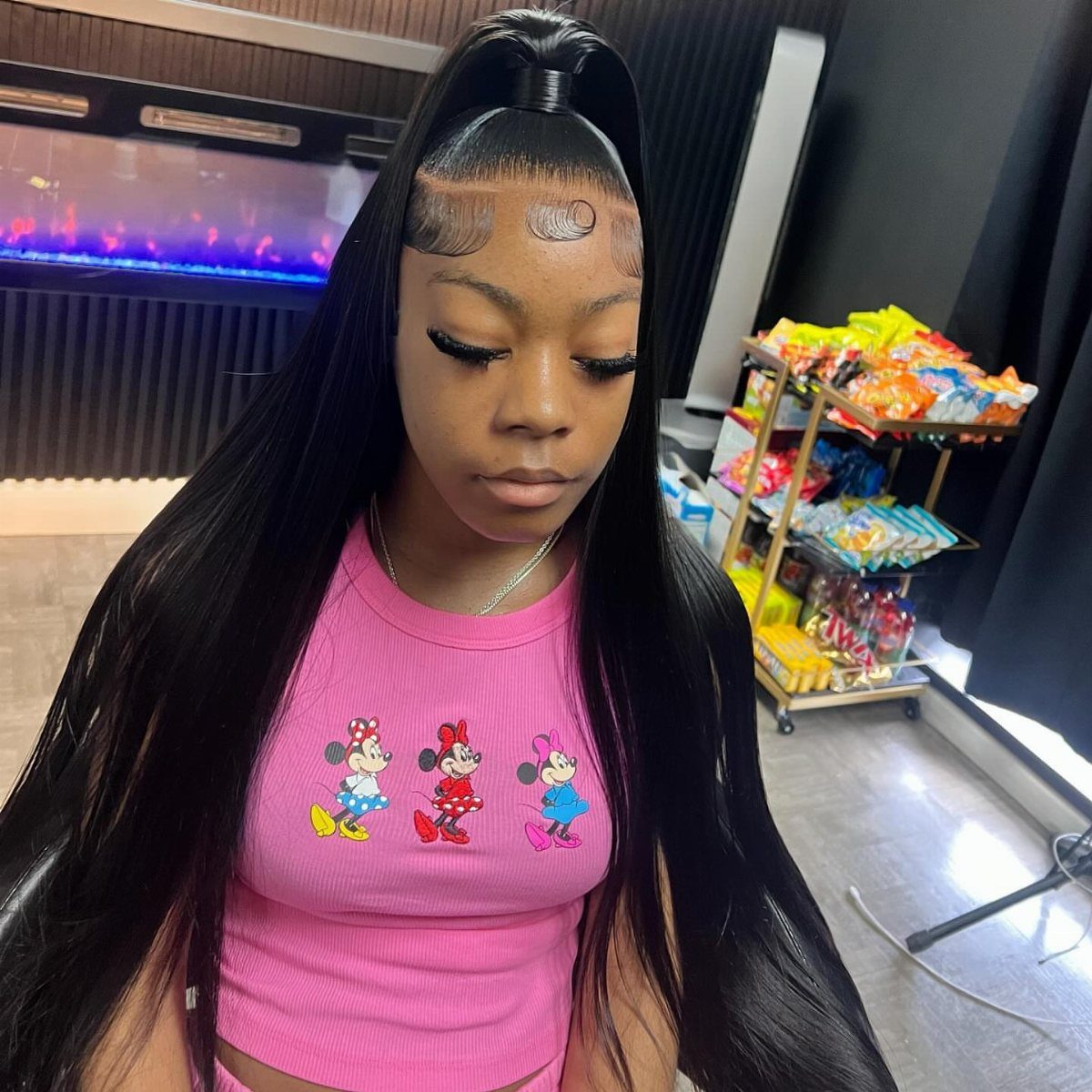11 Picture Day Hair Ideas for Kids, from Braids to Bows 1 Woman with long straight black hair in a high half-up ponytail wearing pink.