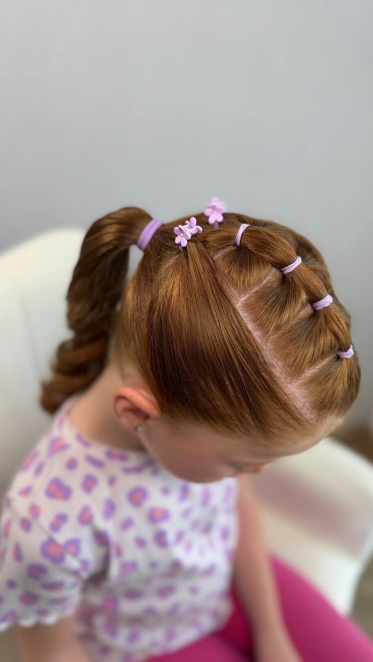 11 Picture Day Hair Ideas for Kids, from Braids to Bows 11 Young girl with reddish-brown hair in a ponytail and purple hair ties.