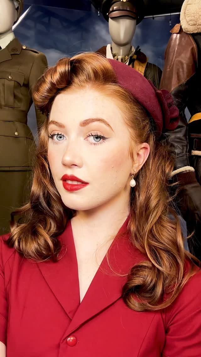 Pin Up Curls Hairstyles to Try: 6 Retro Ideas 6 Woman with red hair in victory rolls and curls wearing a red jacket