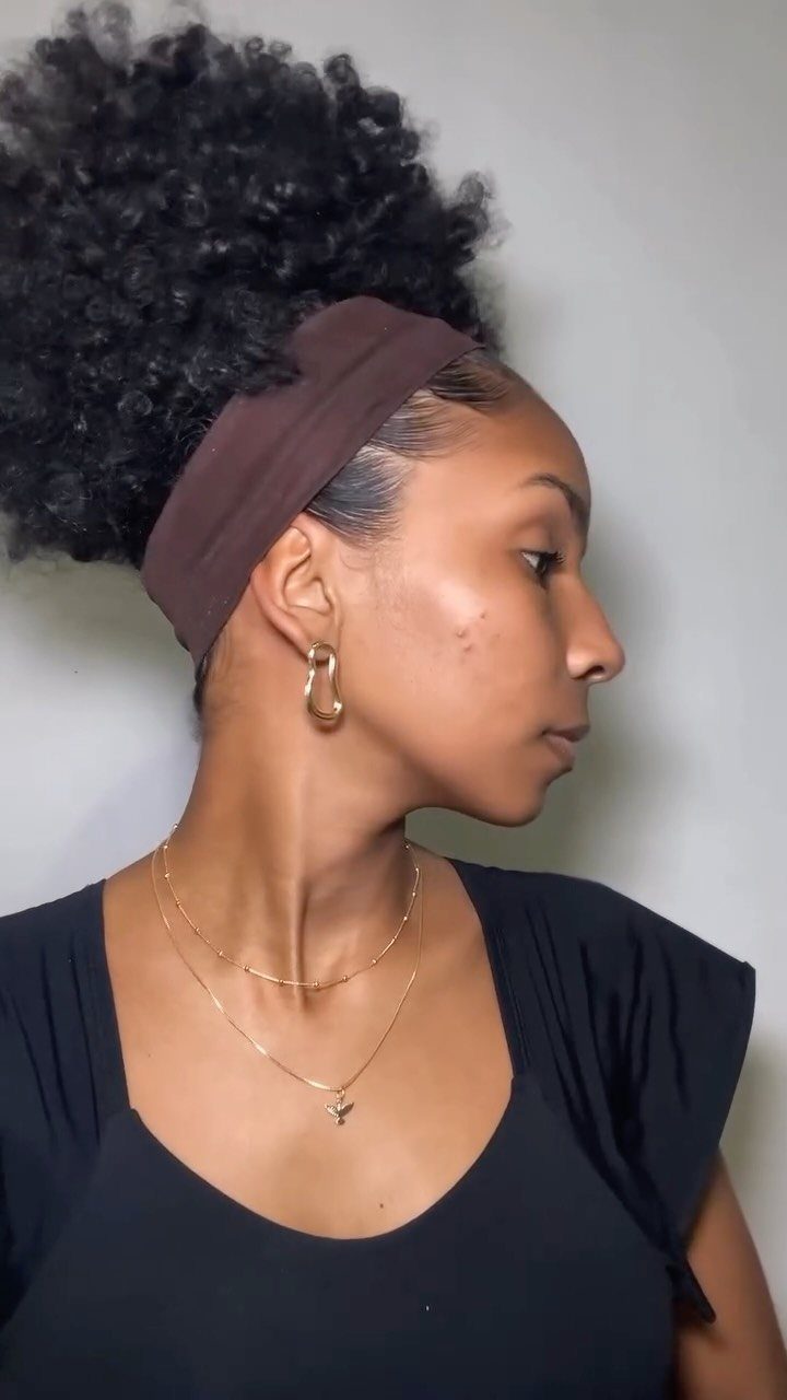 21 Short Curly Hair Styling Ideas for Every Texture 6 Woman with slicked back sides and a voluminous curly top held by headband