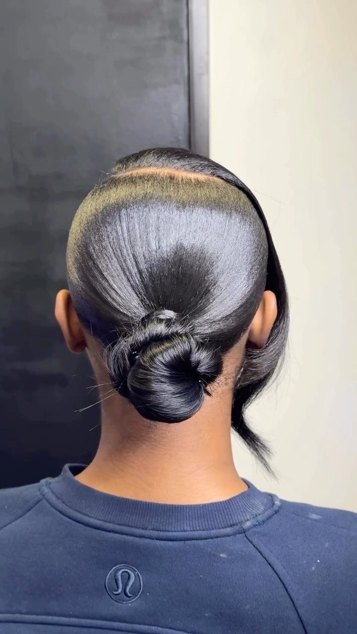 10 Sleek Hair Styles for Every Length and Occasion 9 Dark glossy hair styled into a sleek low bun from the back