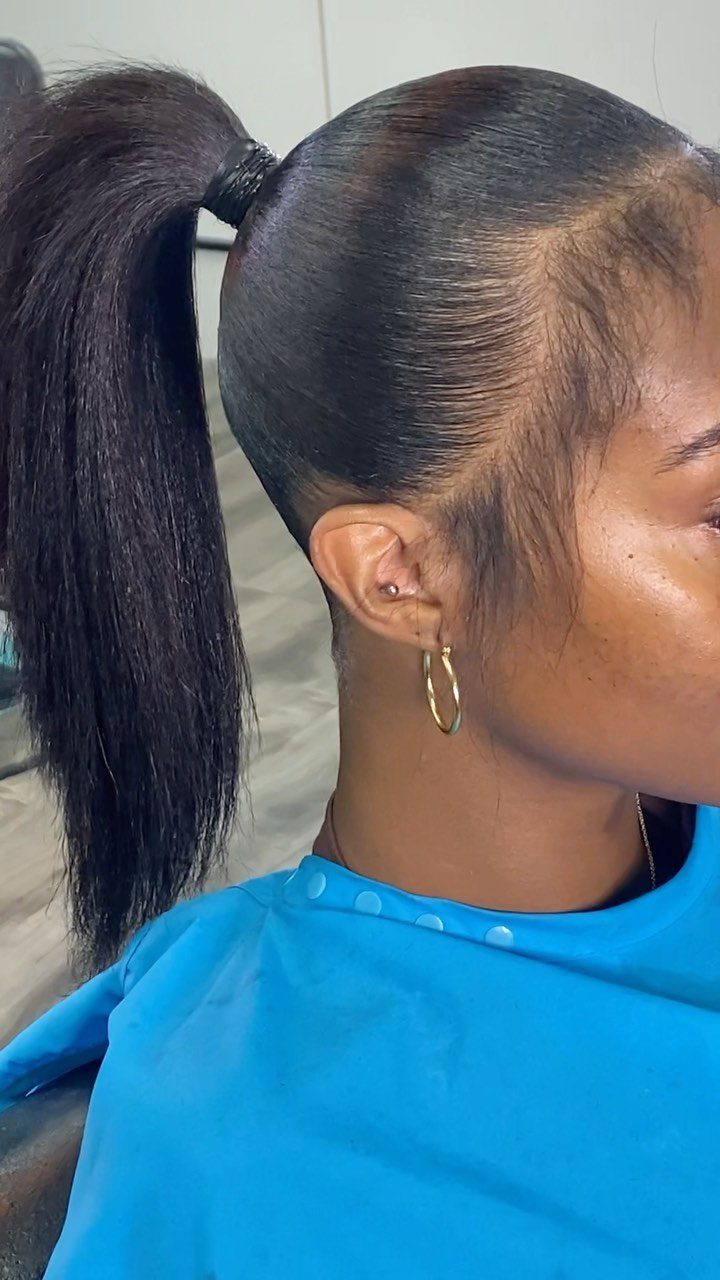 10 Sleek Hair Styles for Every Length and Occasion 1 Woman with a high slicked-back ponytail and polished hair wearing a blue cape.