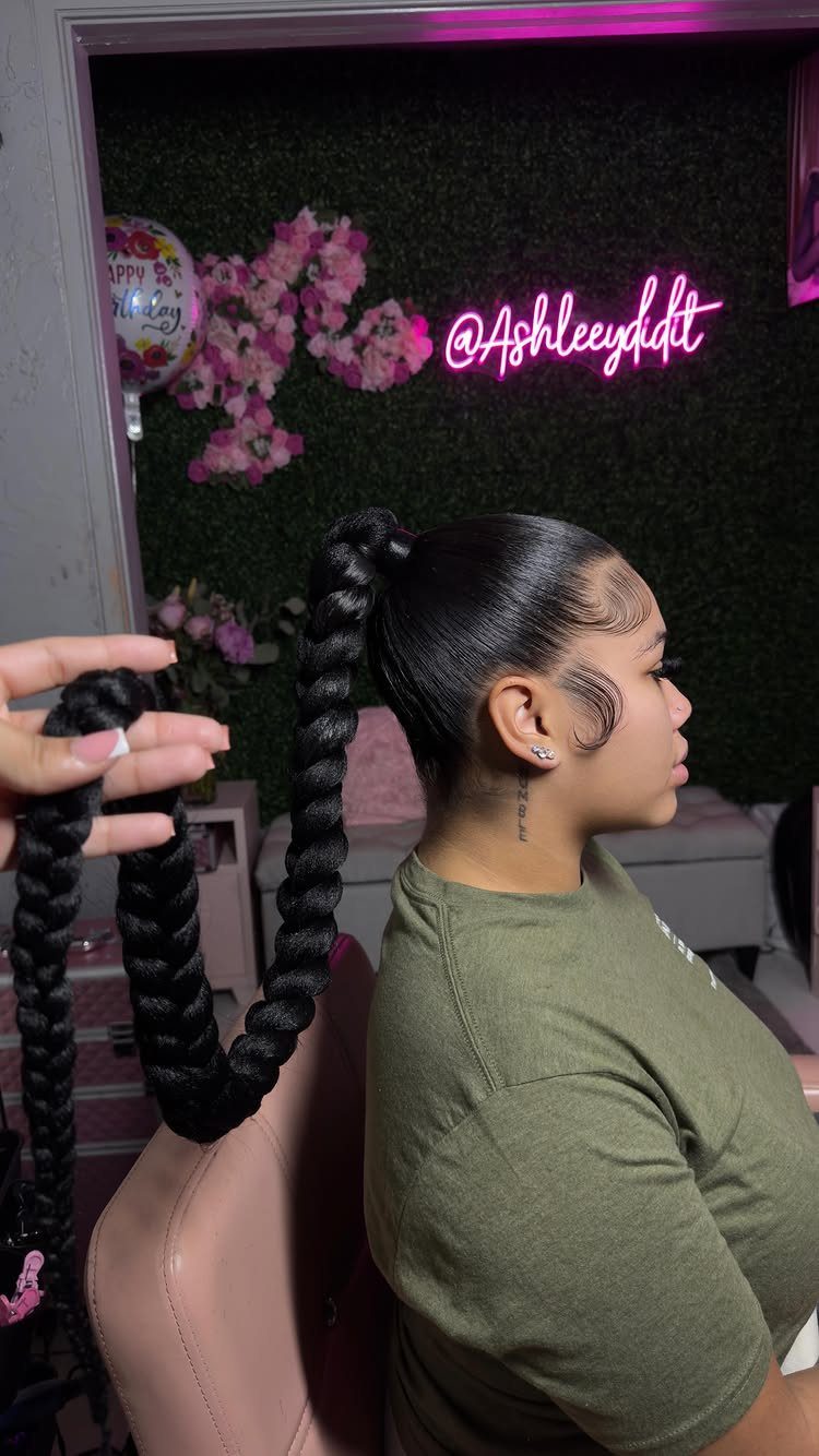 5 Sleek High Pony Ideas with Braids, Curls and Edges 2 Woman with a high, thick braided ponytail and slicked-back hair in profile view.