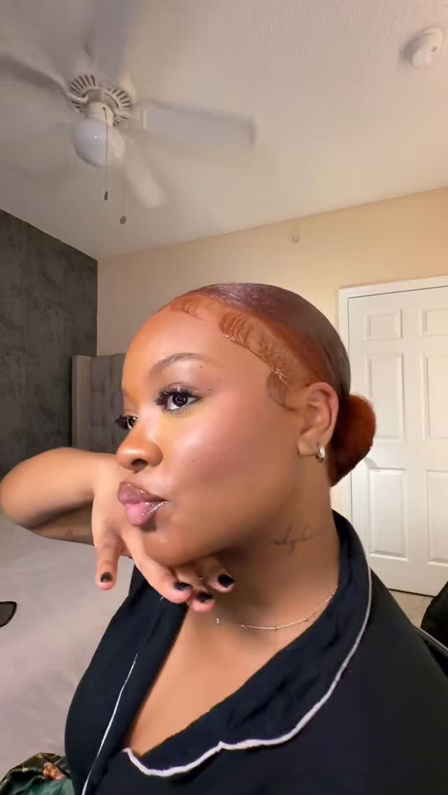 5 Slick Down Ponytail Ideas for Shine, Bangs and Curls 3 Woman with a slicked-back ponytail and styled swoop bangs along her hairline.