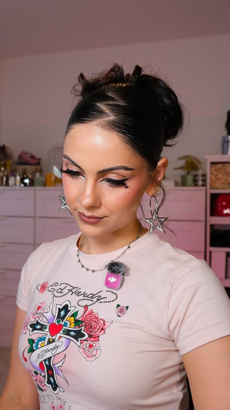 Slickback Messy Bun Ideas: 5 Easy Styles to Try 1 Woman with a slicked-back middle part and a messy bun wearing star earrings.