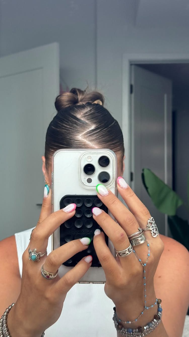 Slickback Messy Bun Ideas: 5 Easy Styles to Try 3 Slicked-back brown hair bun seen from behind in a mirror selfie.