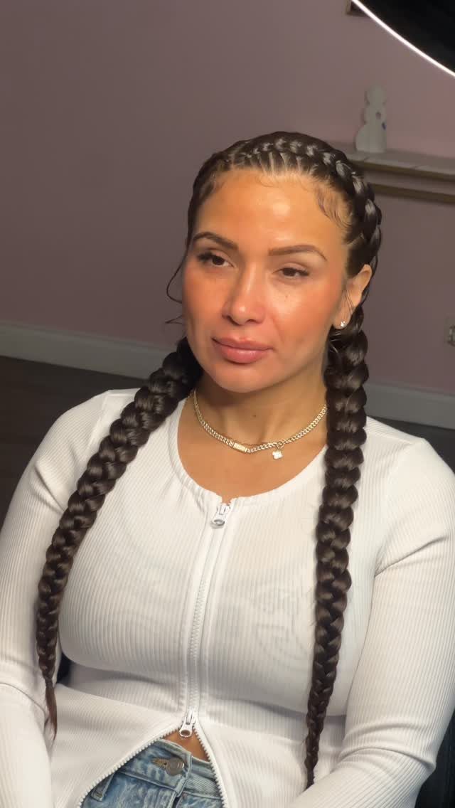 20 Thick Natural Hairstyles for Every Length and Mood 20 Woman with long dark braids and cornrows wearing a white ribbed top.