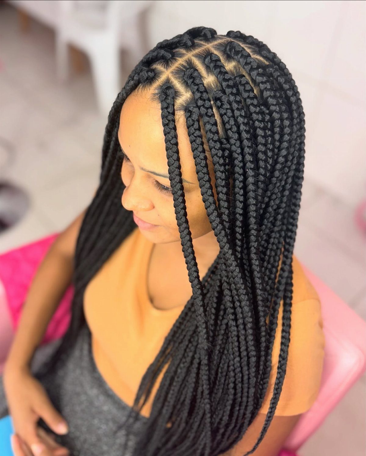 27 Trending Black Hairstyles, from Microbraids to Sisterlocks 3 Woman with long black box braids partitioned in square sections on her scalp