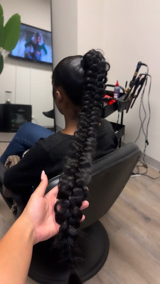 27 Trending Black Hairstyles, from Microbraids to Sisterlocks 15 High bubble braid ponytail on a person sitting in a black salon chair.
