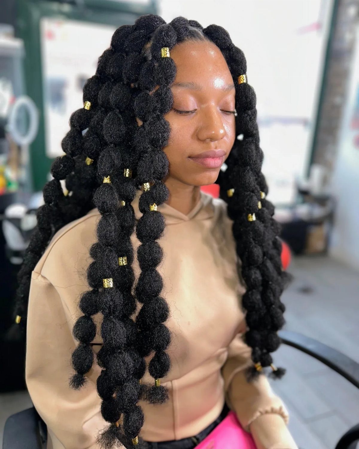 27 Trending Black Hairstyles, from Microbraids to Sisterlocks 13 Woman with long black butterfly locs and gold cuffs wearing a tan hoodie