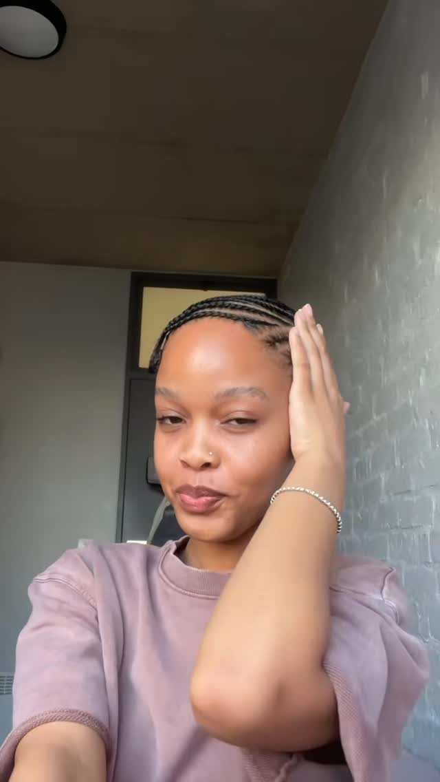 27 Trending Black Hairstyles, from Microbraids to Sisterlocks 4 Woman with sleek cornrows braided flat against her scalp posing indoors.