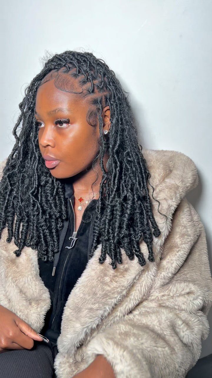 27 Trending Black Hairstyles, from Microbraids to Sisterlocks 18 Woman with long black goddess locs and curly ends wearing a beige fur coat