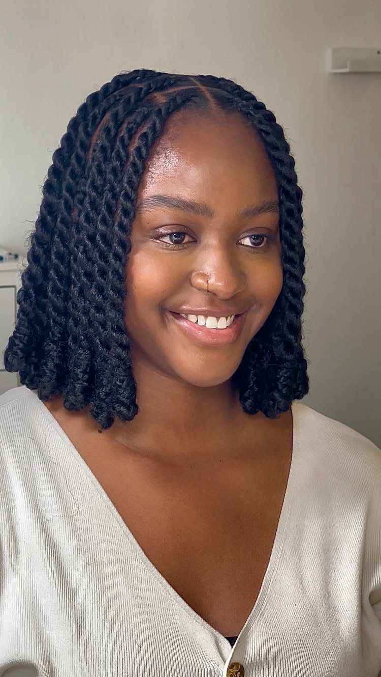 27 Trending Black Hairstyles, from Microbraids to Sisterlocks 11 Black woman smiling with shoulder-length black hair styled in thick, defined twists.