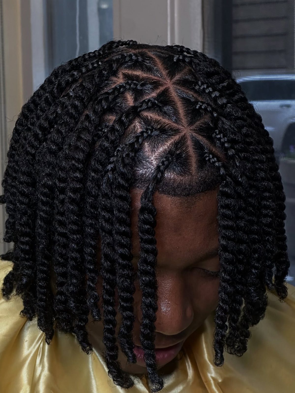 27 Trending Black Hairstyles, from Microbraids to Sisterlocks 21 Person with black hair styled in two-strand twists with a geometric scalp pattern.