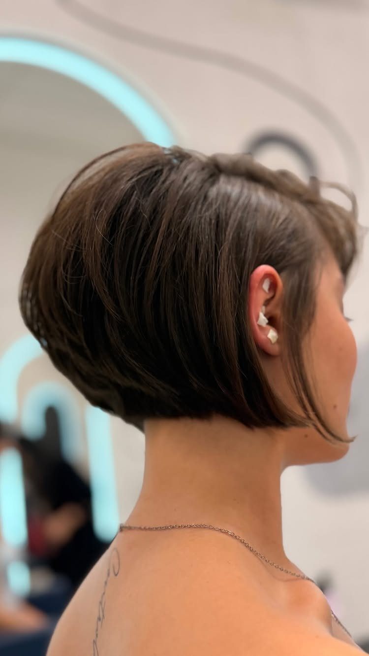 13 Trending Hair Style Ideas, from Curtain Bangs to Pixies 4 Short textured brown bob haircut on a person seen from the side profile.